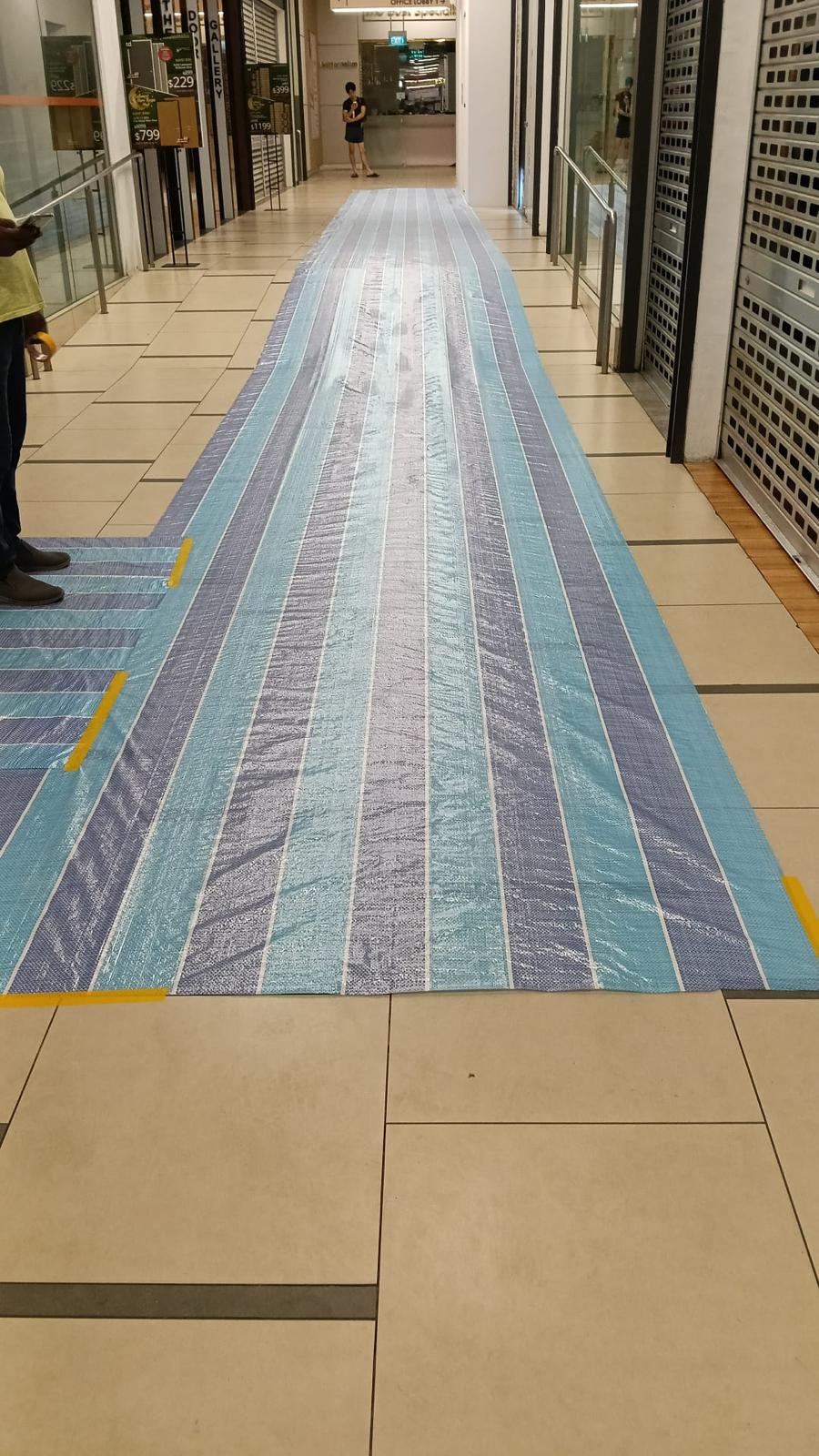 Protection run through a live mall corridor
